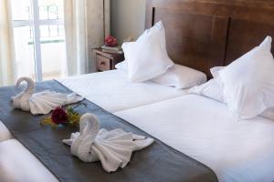 two swans towels on two beds in a hotel room at Hotel Toboso Chaparil in Nerja