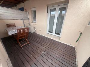 un ponte di legno con un tavolo e una sedia su una casa di La Villa Mar Y Sol - Bord de mer a Fos-sur-Mer