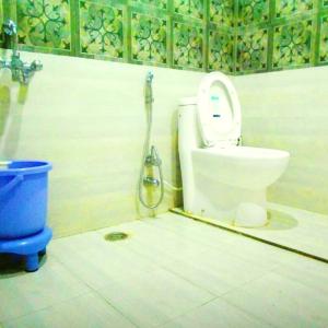 a bathroom with a toilet with a shower at Alta Vista Resort in Joshīmath