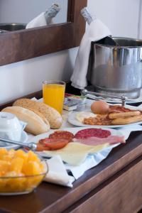 a breakfast tray with breakfast foods and drinks on a table at Hotel Toboso Chaparil in Nerja