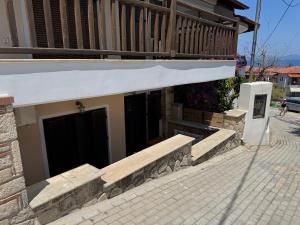 a building with two doors and a stone wall at Το Πέτρινο Σπιτι in Polykhrono