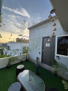 a balcony with a table and chairs on a building at Tropical vibes Private, Terrace, Cozy space- Gurgaon and NCR in Gurgaon