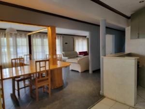 a kitchen and living room with a table and chairs at Bel Canto Lodge in Fombeni
