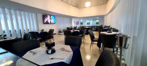 a dining room with tables and chairs in a restaurant at Omedad Hotel in Dirē Kʼalu