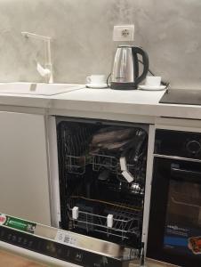 an open oven with a tea kettle on top of it at Grit old Bazaar apartment in Tirane