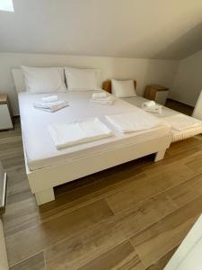 a large white bed with two servers on it at Villa Ajdinoski in Ohrid +21 photos