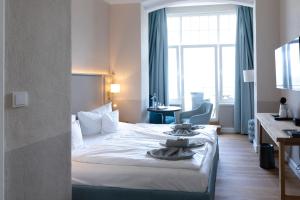 Postel nebo postele na pokoji v ubytování Hotel Germania
