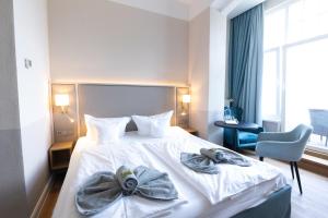 Postel nebo postele na pokoji v ubytování Hotel Germania