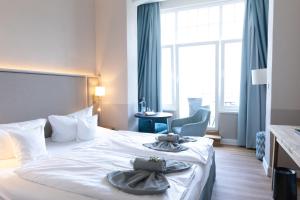 Postel nebo postele na pokoji v ubytování Hotel Germania