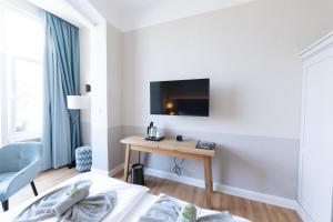 TV a/nebo společenská místnost v ubytování Hotel Germania