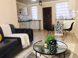 a living room with a couch and a table at Blanc and Bold in Kempton Park