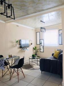 a living room with a couch and a table at Blanc and Bold in Vosburg