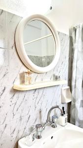 een badkamer met een spiegel en een wastafel bij Viki Studios in Pefki