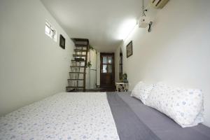 a bedroom with a bed and a book shelf at Bu House Hanoi Old Quarter in Hanoi