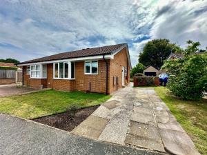 a brick house with a driveway in front of it at Cosy bungalow Branton Doncaster near Yorkshire wildlife park and doncaster centre in Cantley