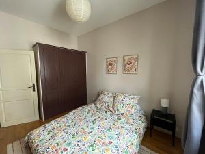 a bedroom with a bed and a brown cabinet at sainte anne petite venise colmar in Colmar
