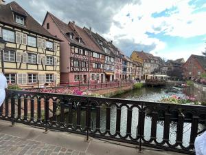 a river in a city with buildings and a bridge at sainte anne petite venise colmar in Colmar