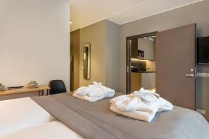 Postel nebo postele na pokoji v ubytování Hessnery Hotel