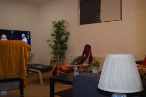 a living room with a couch and a tv at The Ranch House Bragadiru in Bragadiru