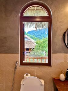 a bathroom with a toilet and a window at Xoi Farmstay - A Home Farm in Lam Thuong valley - North Vietnam in Lung Co (1) +123 photos