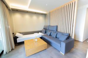 a living room with a couch and a table at Villy Luxury Home by the Sea 2 in Ayiá