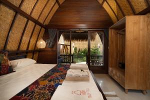 a bedroom with two beds in a room at Tricky Trees Sunset Bungalows in Gili Air