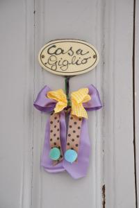 a door sign with a bow on a door at Casa Giglio in Ostuni