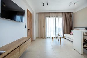 a living room with a couch and a table at Emmeli's de lux apartments 1 in Skala Marion