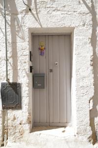a white door in the side of a building at Casa Giglio in Ostuni