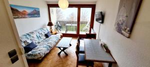a living room with a couch and a table at La Monarde in Gérardmer