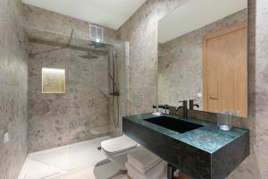 a bathroom with a sink and a toilet and a shower at Arlequin Suites in Marbella +11 photos