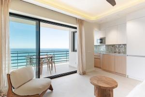 a living room with a view of the ocean at Arlequin Suites in Marbella