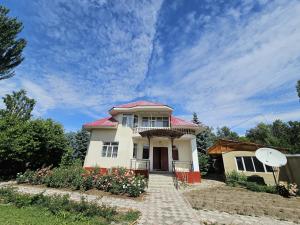 a small white house with a red roof at Talas guest house in Talas