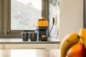 a coffee maker sitting on a counter next to a window at Luxury 2BR Sky Suite City Views & Prime Location in Cape Town +39 photos
