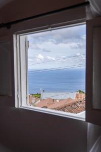 a view of the ocean from a window at Refúgio do Sossego in Pedreira