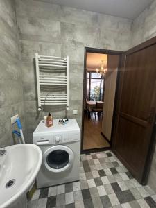 a bathroom with a washing machine and a sink at Eco House in Makhinjauri