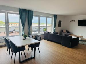 a living room with a table and a couch at Smart In Kassel - Boardinghouse in Kassel