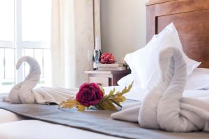 a bedroom with two swans towels on a bed at Hotel Toboso Chaparil in Nerja