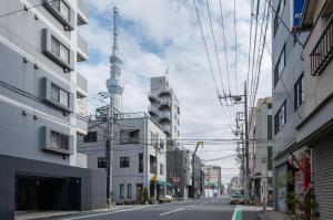 an empty city street with the television tower in the background at Daffitto Honjo Azumabashi in Tokyo