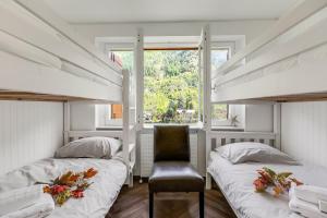 a bedroom with two bunk beds and a chair at Boutique Apartment Limone Ski In Ski Out - Happy Rentals in Limone Piemonte