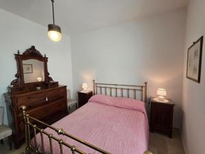 a bedroom with a bed and a dresser and a mirror at Casa DiMa - La Pigna Verde in Taormina