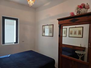 a bedroom with a bed and a dresser and a window at Casa DiMa - La Pigna Verde in Taormina +13 photos