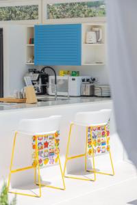 two chairs sitting in front of a kitchen counter at Dolceterra Eolian Villas in Lipari +40 photos