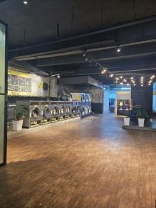 a large room with a wooden floor in a building at Comfy Empire Damansara Studio in Petaling Jaya