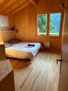 a bedroom with a bed in a wooden cabin at Carpe Diem in Sixt