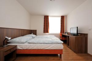Postel nebo postele na pokoji v ubytování Hotel Kácov