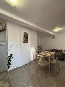 a living room with a table and a couch at Olive Stonehouse in Plomarion +15 photos