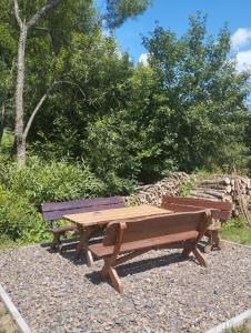 two wooden benches sitting next to each other at Agroturystyka BieszCzadowa Dolina Cisna in Cisna +10 photos