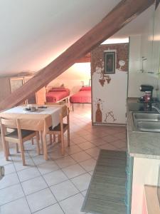 a kitchen with a table and a room with a bed at Dolomiti Garden Apartment in Terzolas +14 photos