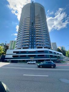 a large building with cars parked in front of it at Sunset Studio - 12th Floor in Cluj-Napoca